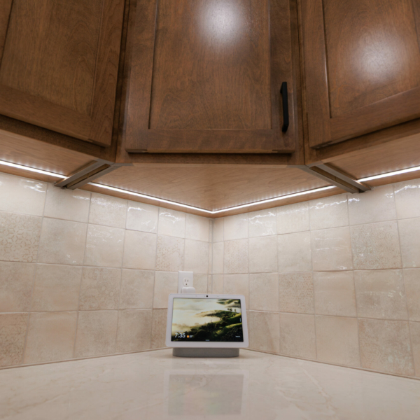 Google Home and corner of under cabinet strip lights.