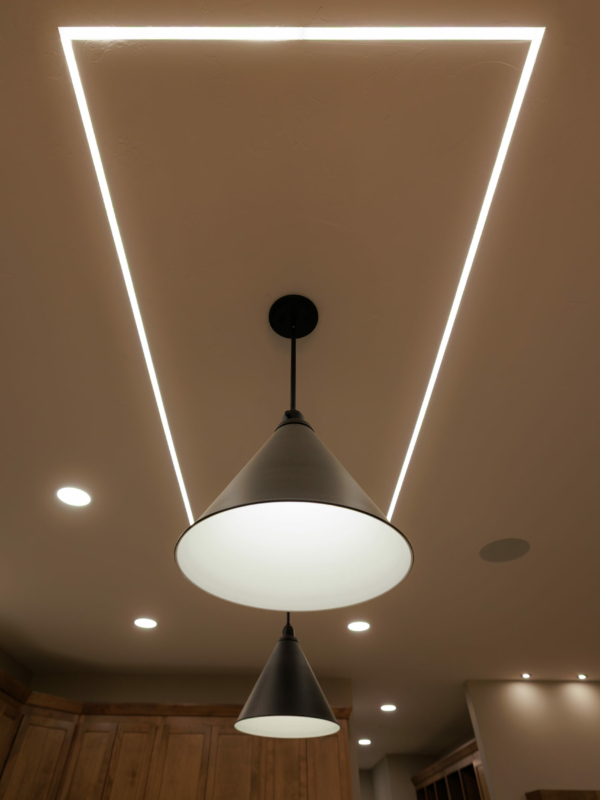 Custom ceiling mounted fixtures bordered with recessed light strips