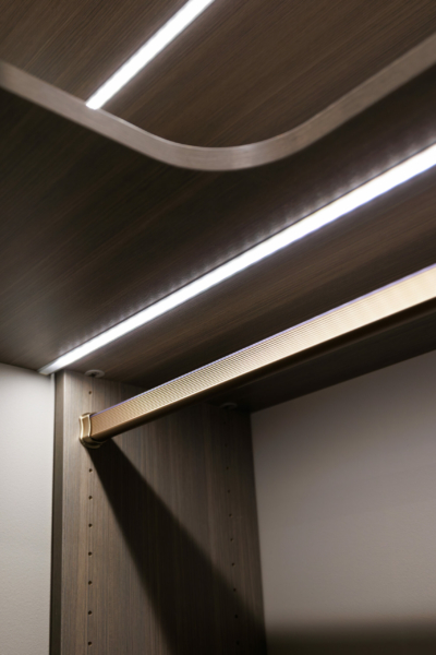 Detailed shot of strip lights under master closet shelves.