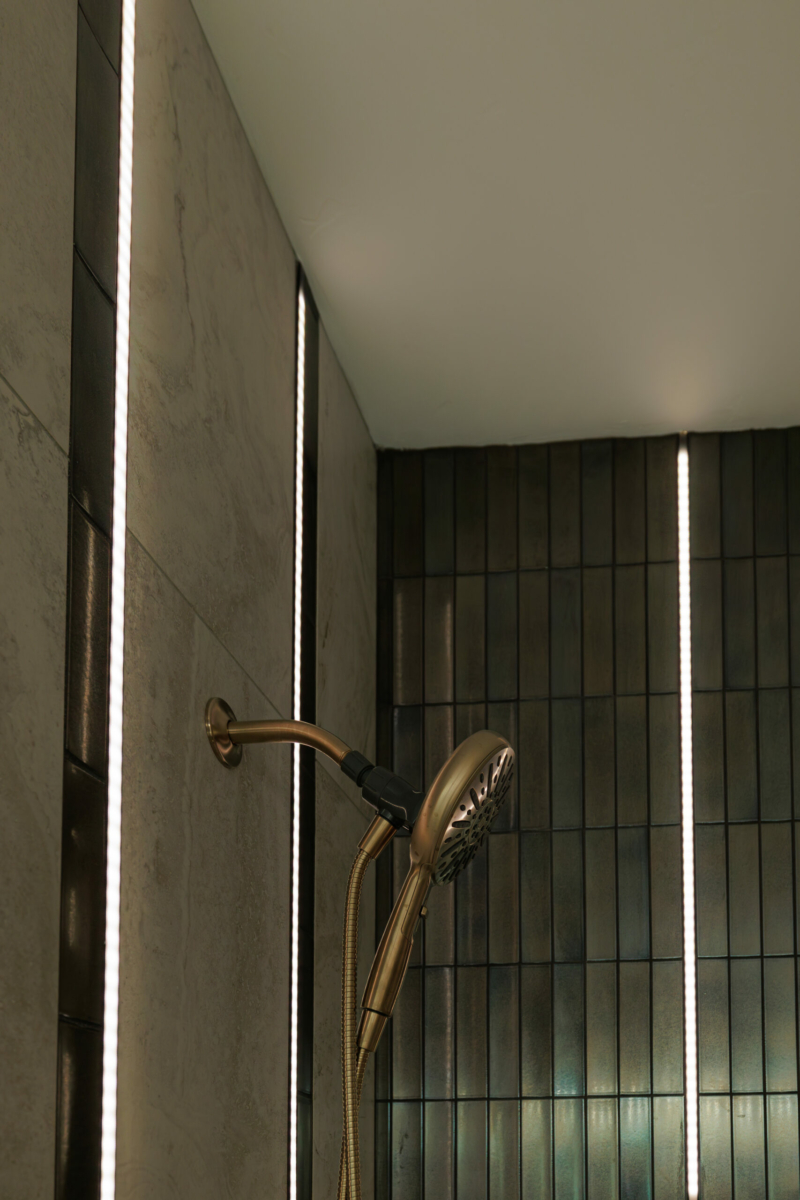 Elegant vertical light strips in the shower walls.