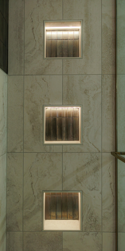 Recessed Lighting in three vertical square shower shelf niches