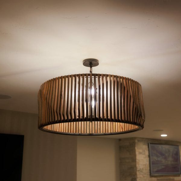 Hanging paneled light fixture reflecting light pattern on ceiling